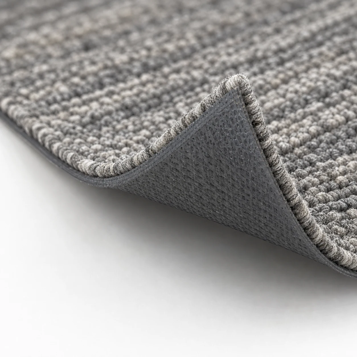Lifted corner detail of PVC-free PE backing commercial carpet tile